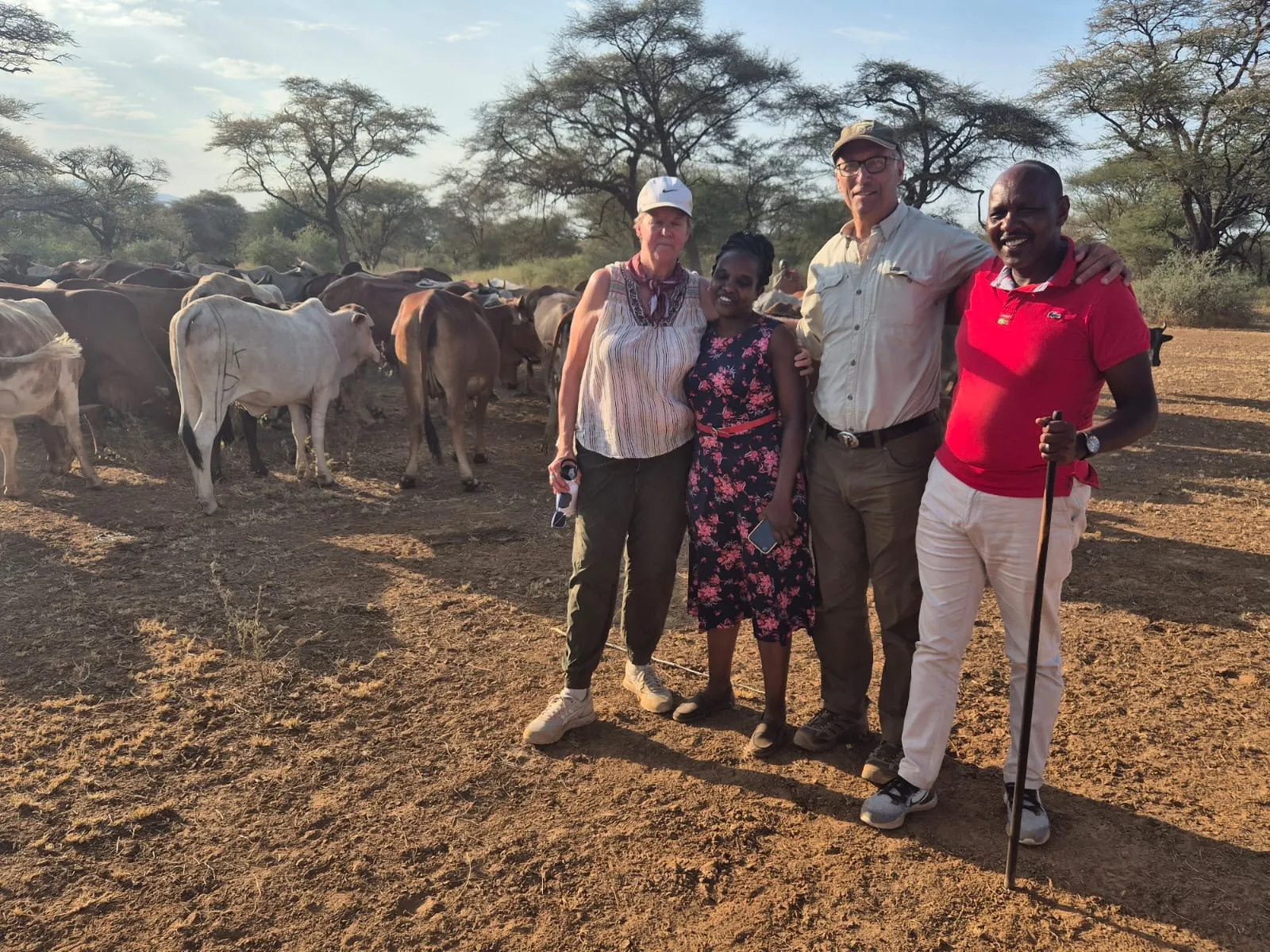 zoo director and director of SORALO posing for photo in front of herd of cows